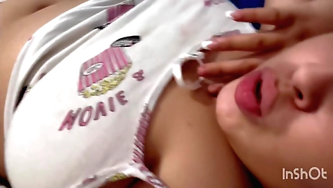 Brunette in sexy clothes is taking off and rubbing her tits