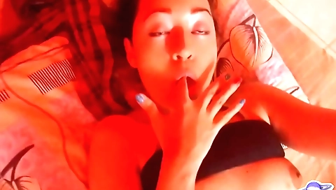 Brunette with big boobs masturbates on the room table